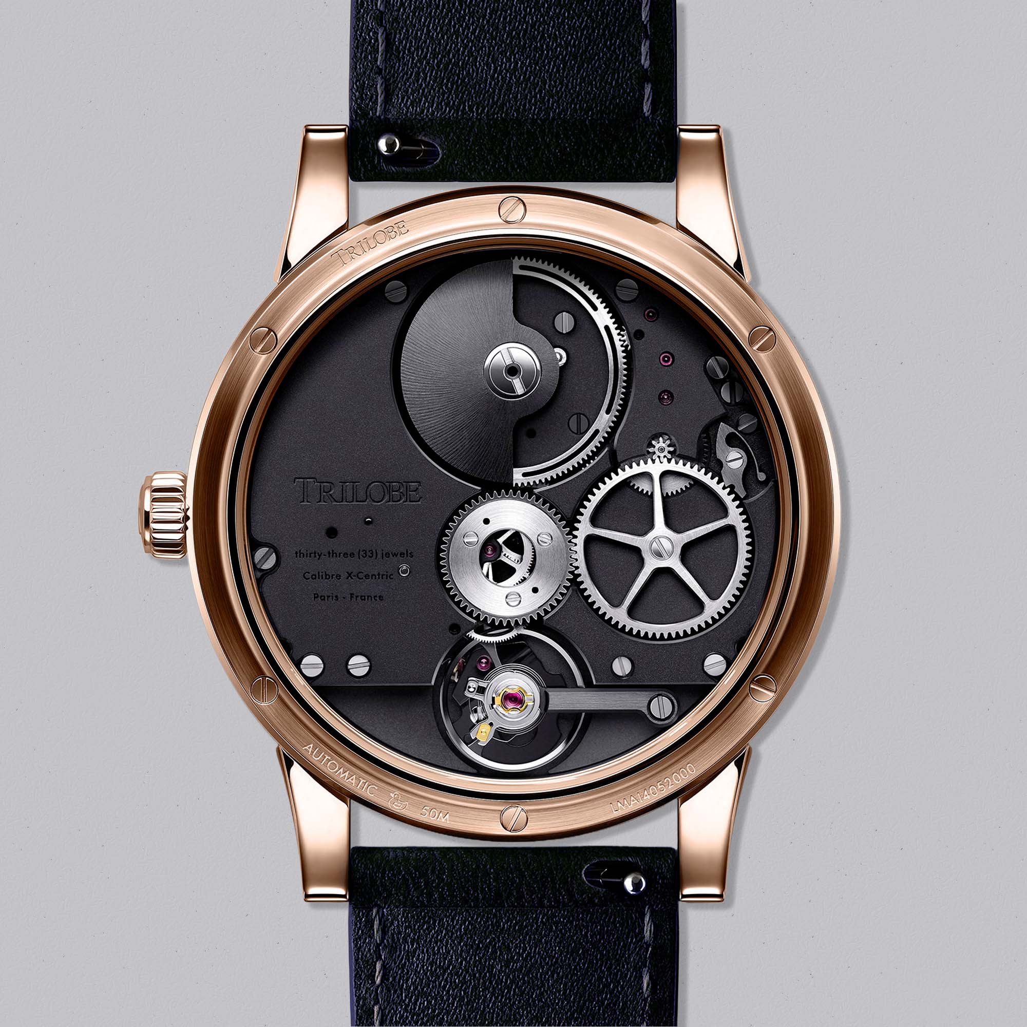 Experience time differently with Trilobe Les Matinaux L’Heure Exquise — a rose gold watch with a deep blue dial and signature eccentric display.