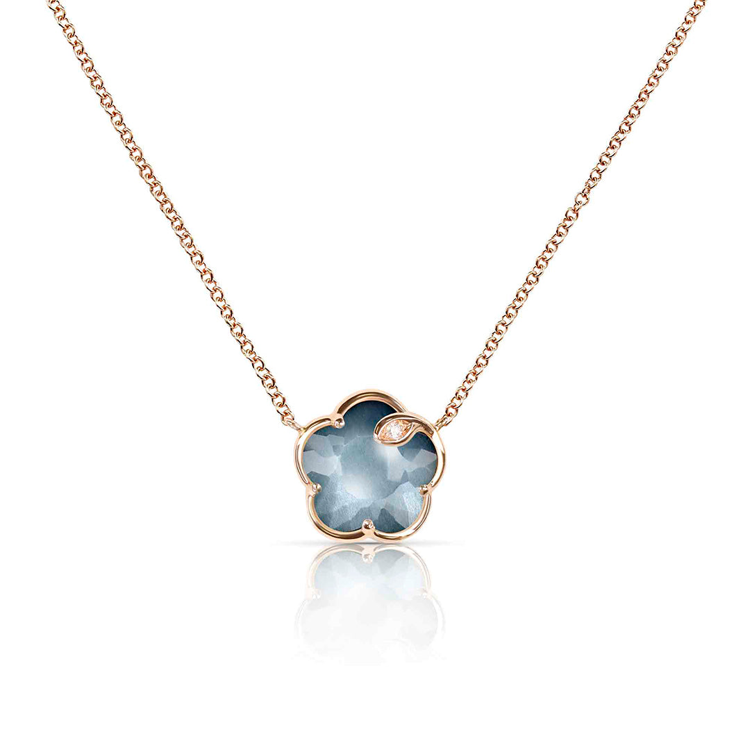 The Petit Joli Necklace in 18K rose gold features deep blue Lunar Night stone framed by a delicate diamond halo. A refined contrast of colour and brilliance.