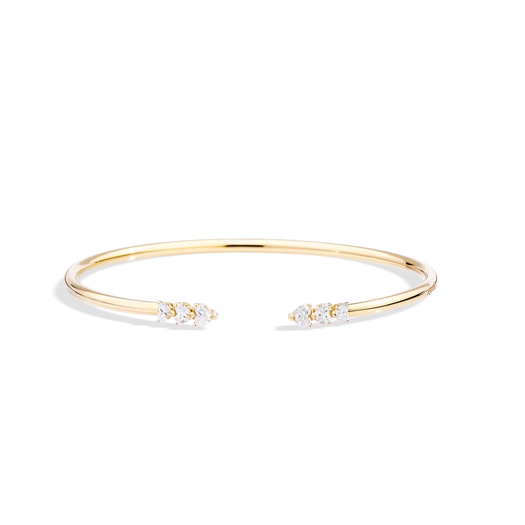 Gold bracelet with small diamonds on a white background