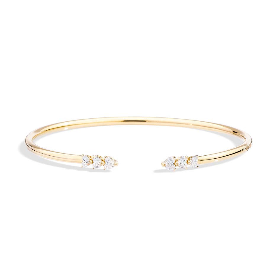 Gold bracelet with small diamonds on a white background